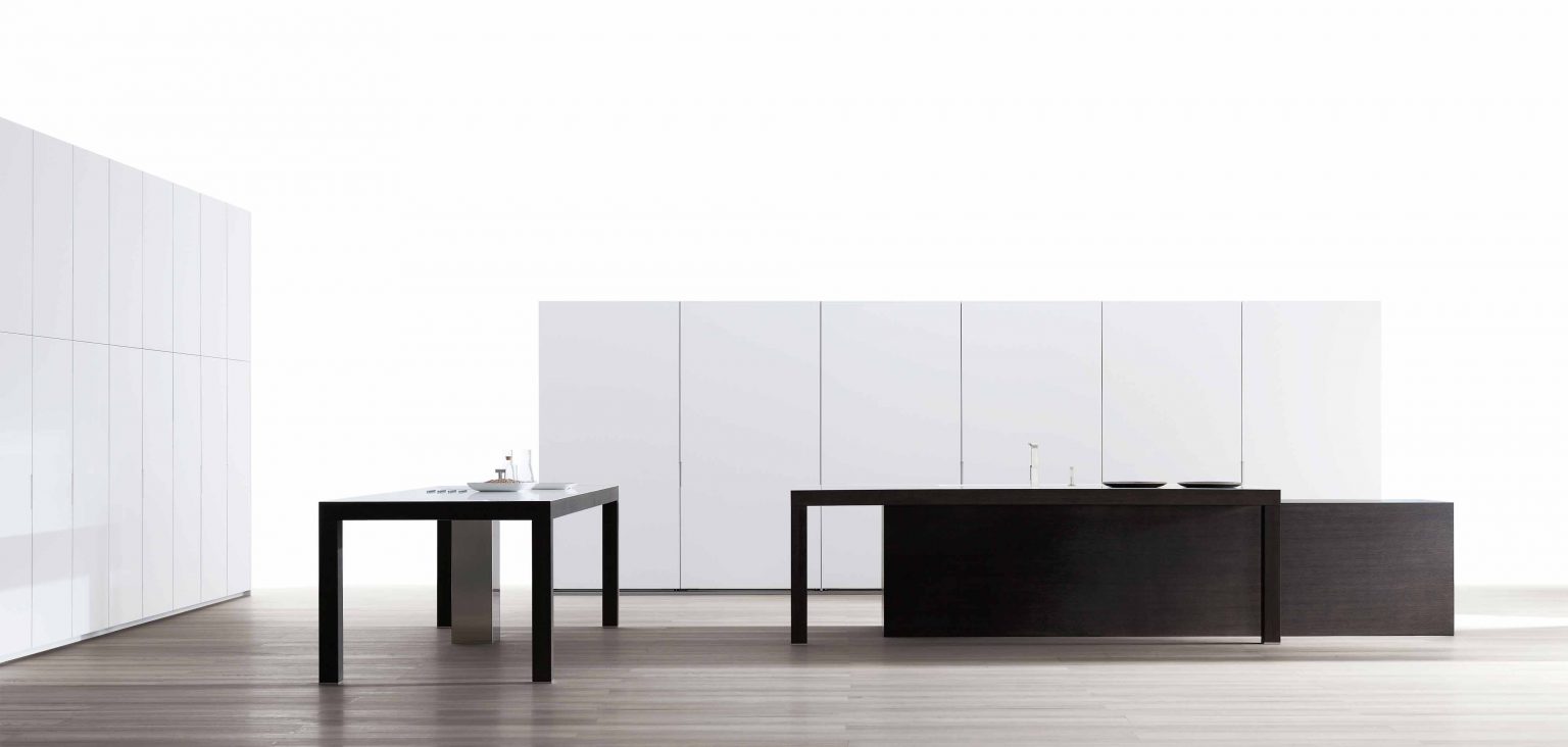 Minimalist kitchen design with sleek white cabinetry and contrasting dark wood island.