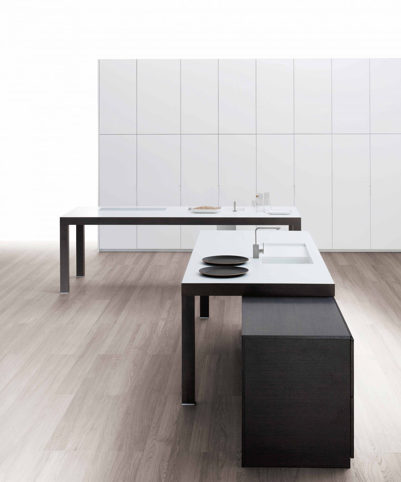 Minimalist kitchen design with sleek white cabinetry and contrasting dark wood island.