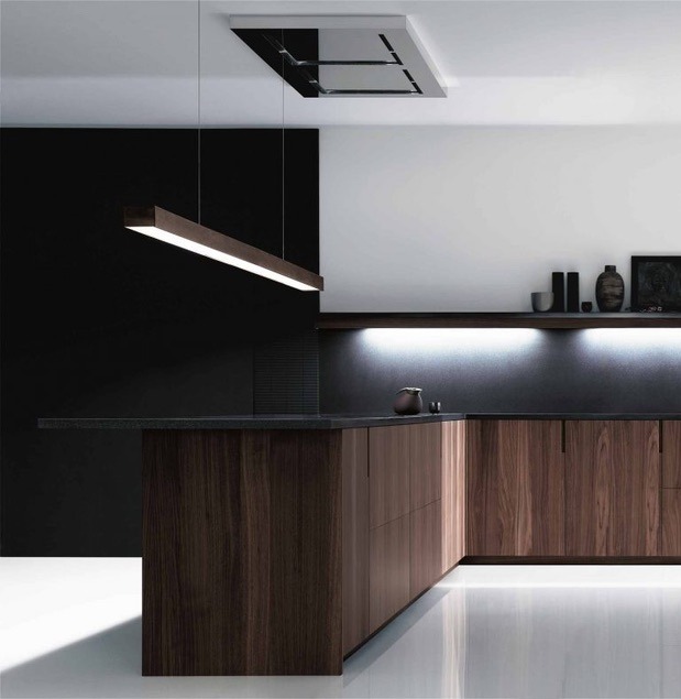 Minimalist kitchen with sleek, dark wood cabinetry, reflective surfaces, and ambient lighting.