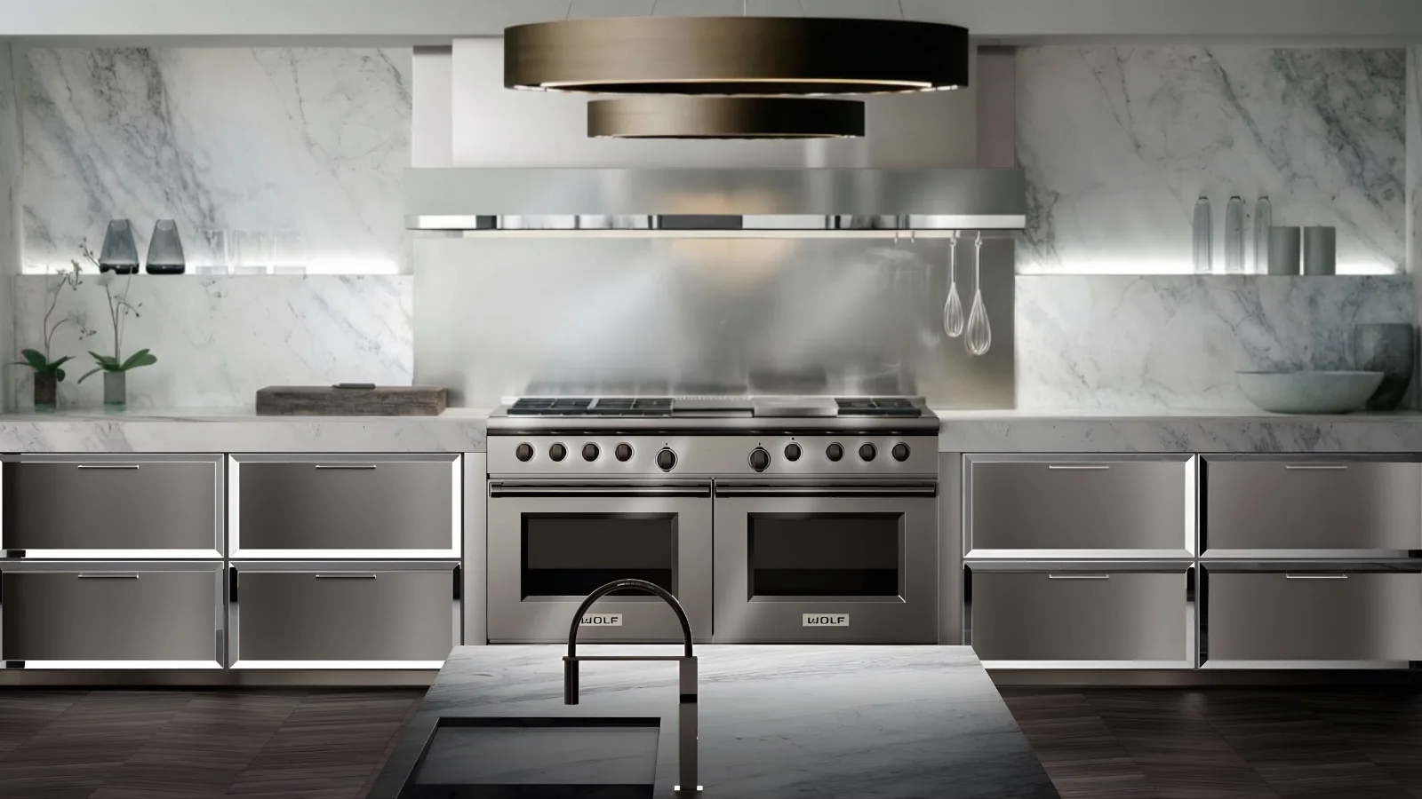 Professional stainless range and ventilation hood against a marble backsplash