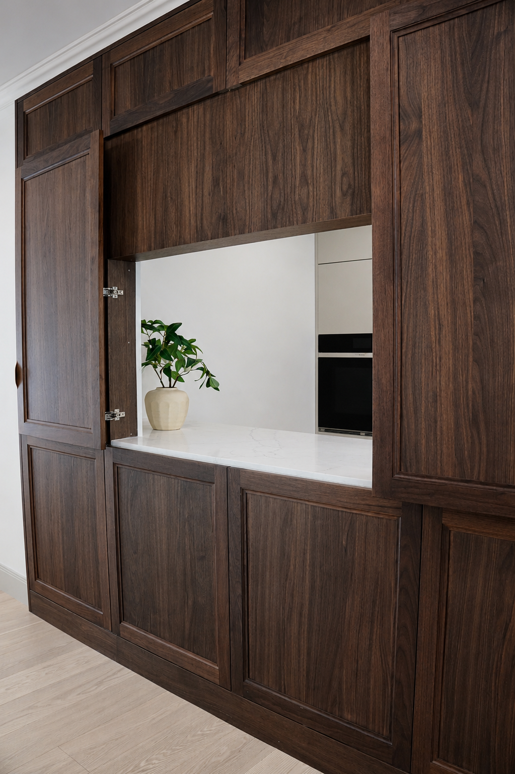 Dark wood cabinetry with an open niche in the Clinton Road kitchen