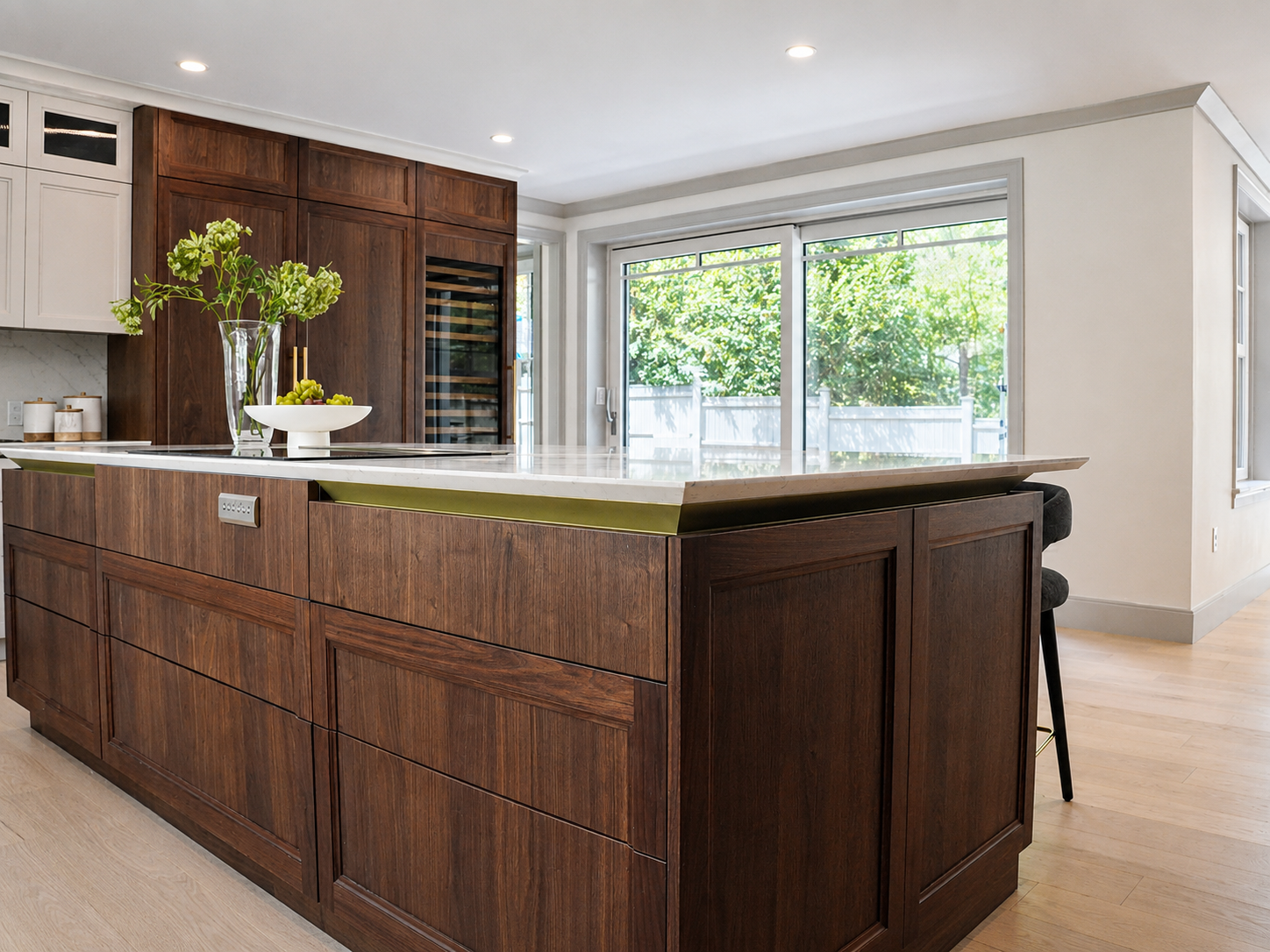 Dark wood island with drawers and a window view in the Clinton Road kitchen