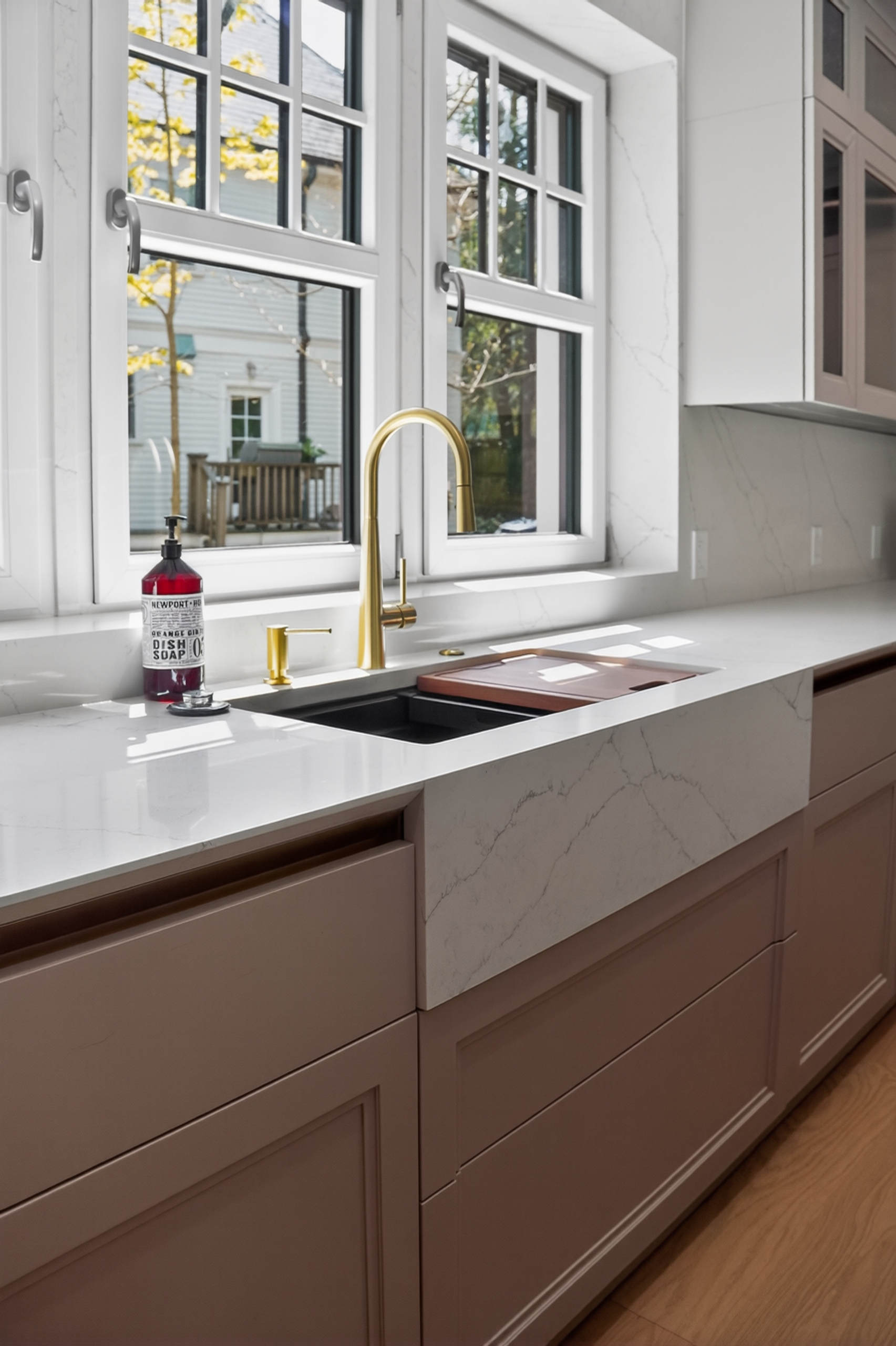 Gold-toned faucet at a pale veined sink in the Clinton Road kitchen