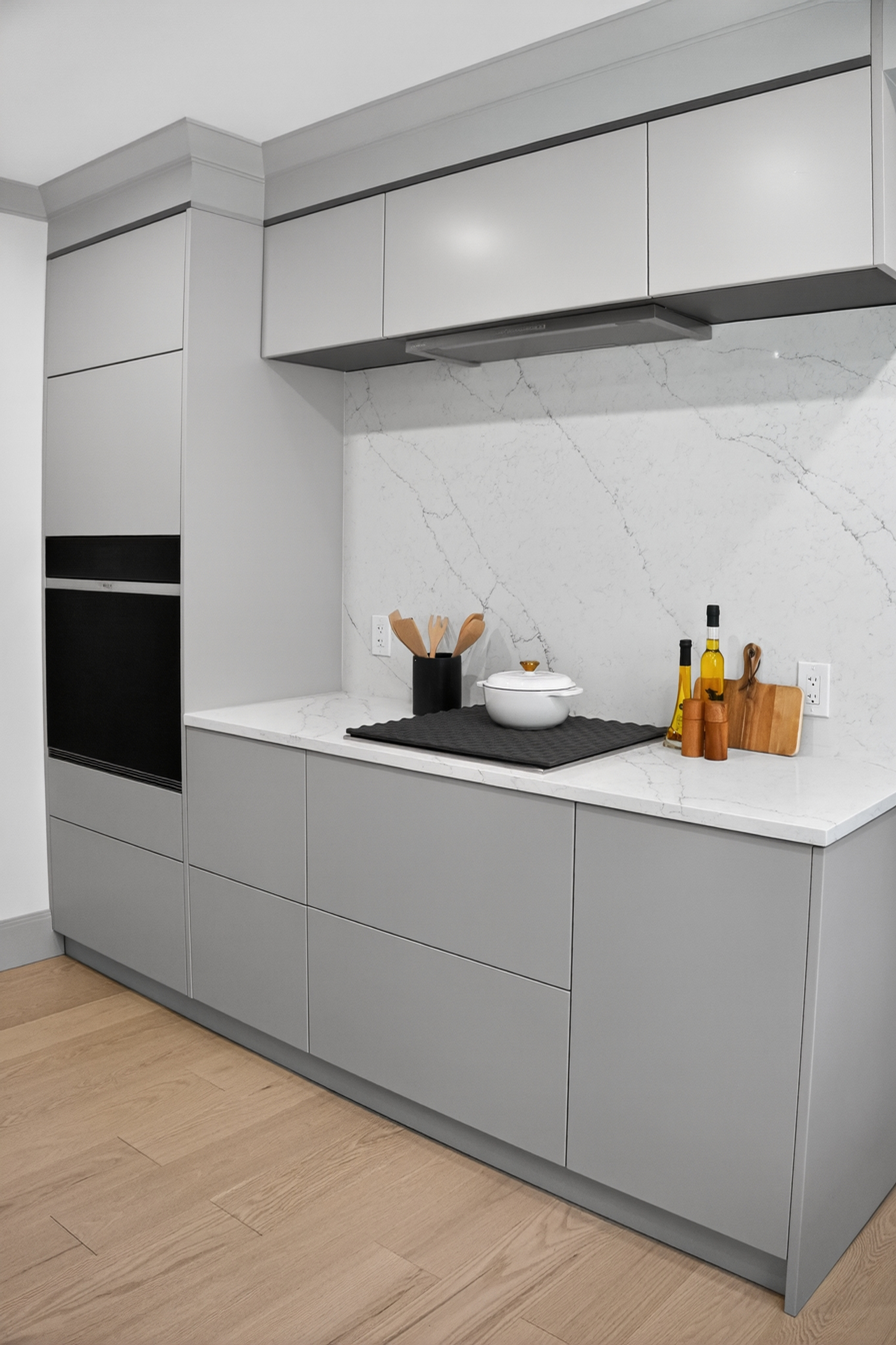 Gray cooktop cabinetry with a pale veined backsplash on Clinton Road