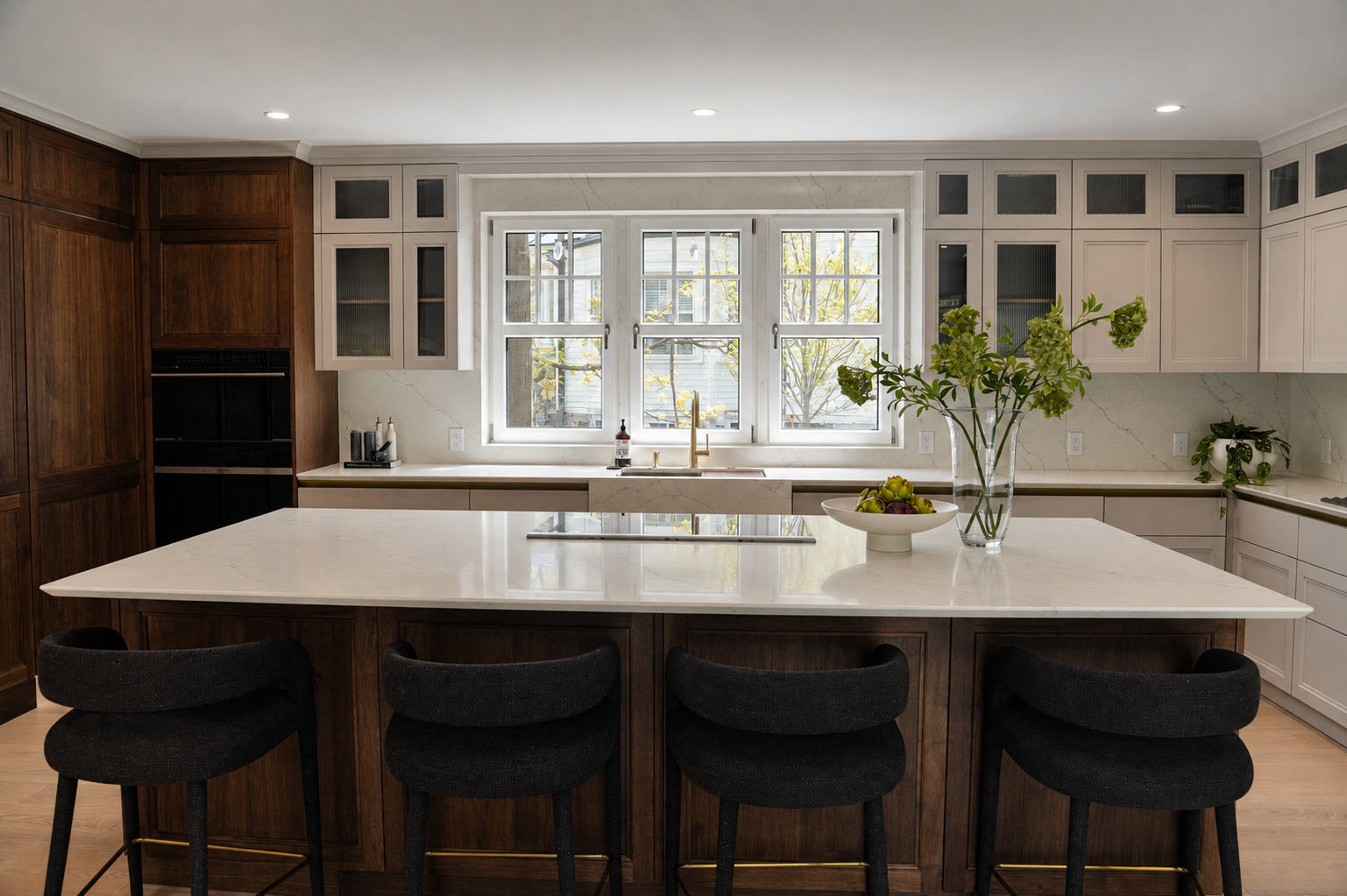 Pale veined island facing a window with dark wood cabinetry on Clinton Road