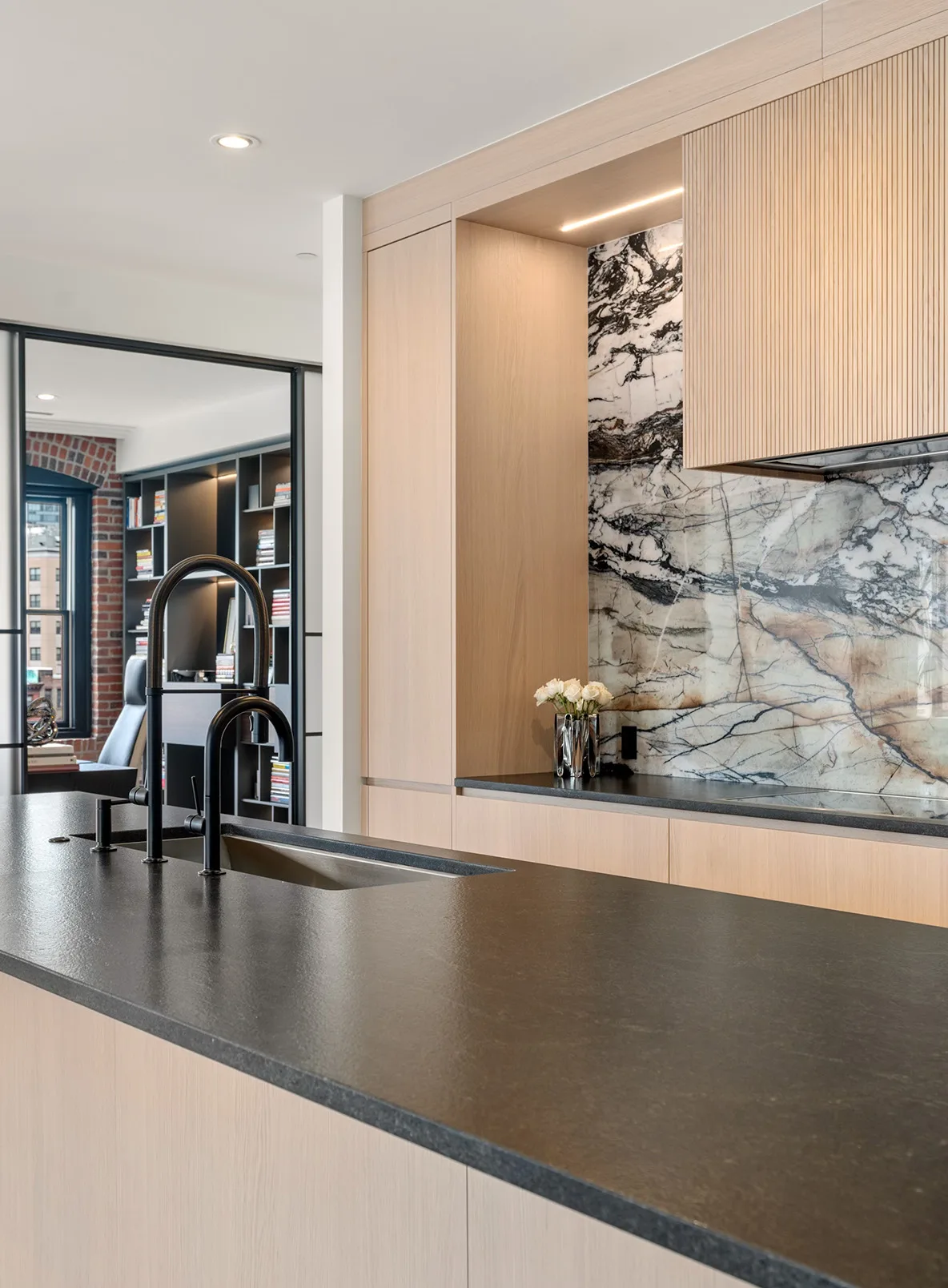 Pale oak cabinetry and dark stone counter in the Curated Canvas kitchen