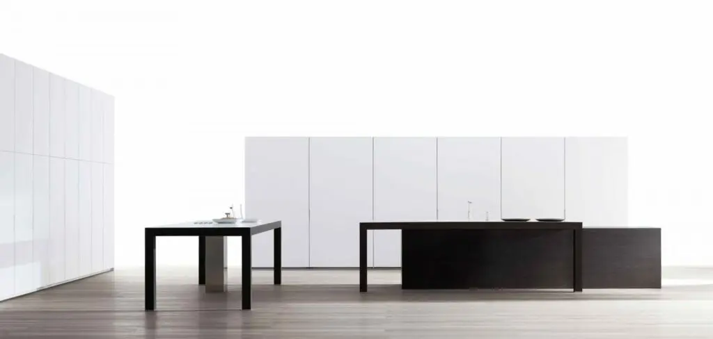 Minimalist transitional kitchen with sleek white cabinetry and contrasting dark wood island and table, featuring clean lines and a spacious layout.